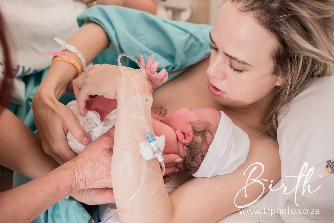 A mother kissing her baby for the first time