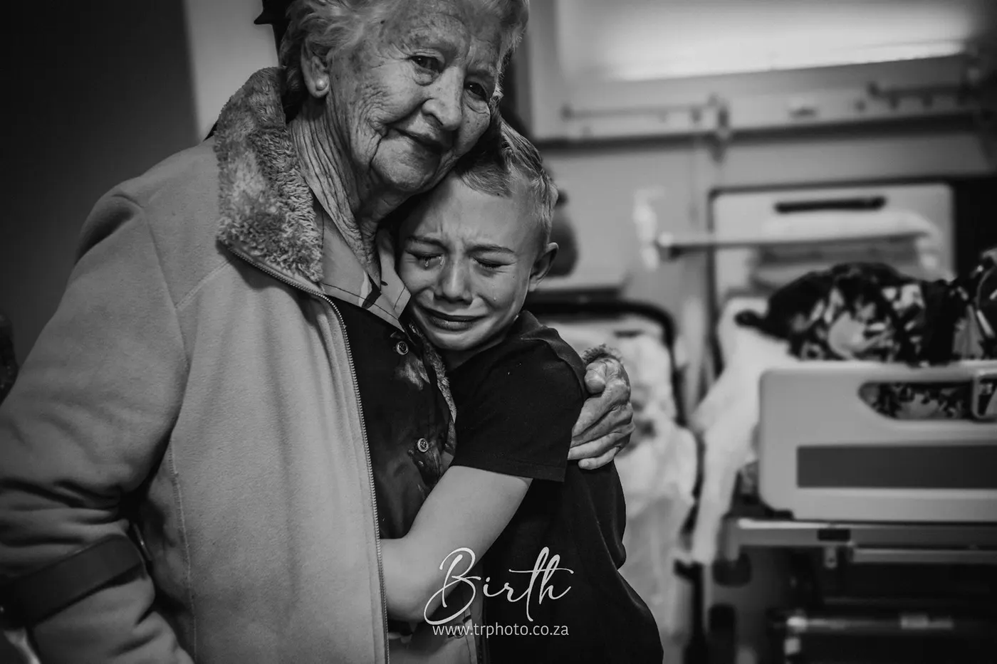 A grandmother hugging her daughter after the birth
