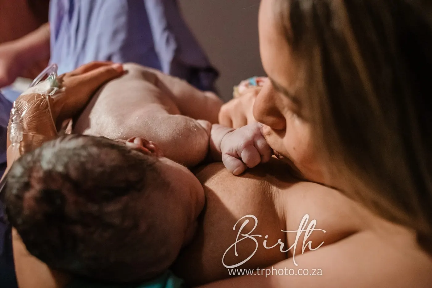 A mother holding her newborn skin to skin moments after birth