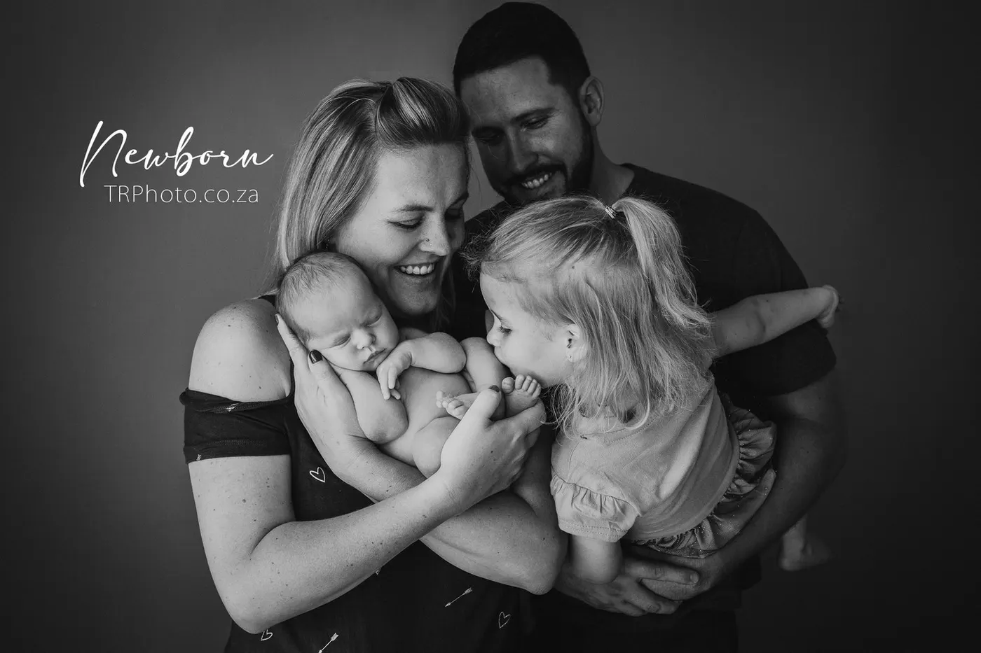 Parents and big sister with their newborn