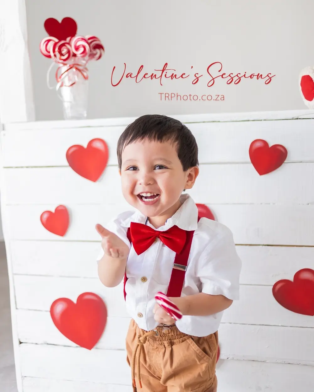 A little boy laughing at a Valentine's mini session
