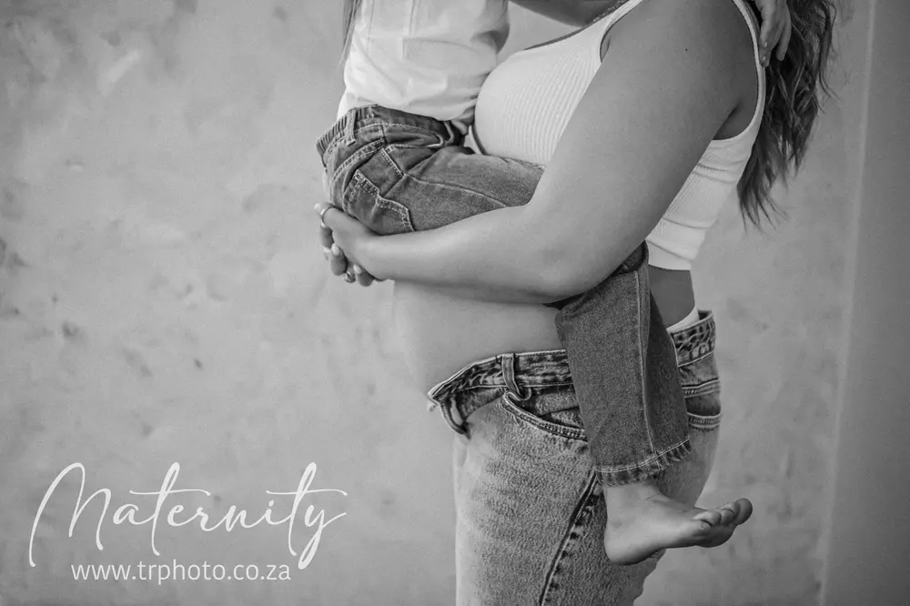A big brother hugging his mum's bump